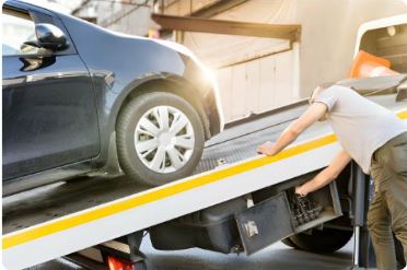 Car being loaded onto a tow truck